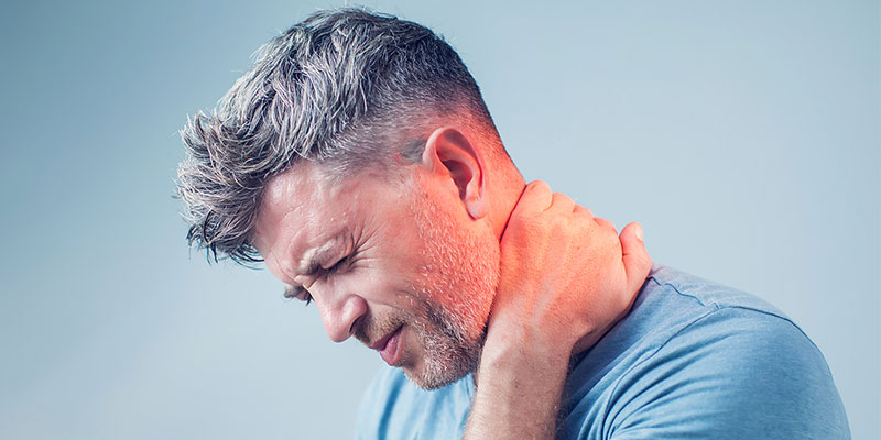 Man holding his neck with neck pain in Gresham OR